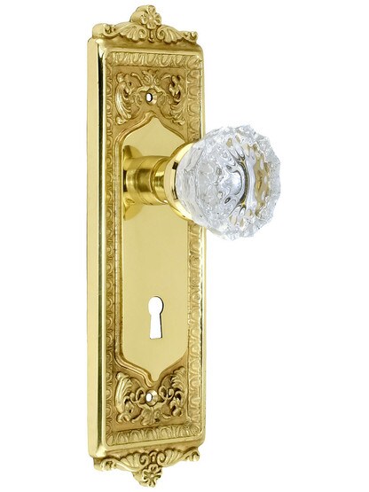 Egg and Dart Style Mortise Lock Set with Fluted Crystal Door Knobs in Unlacquered Brass.